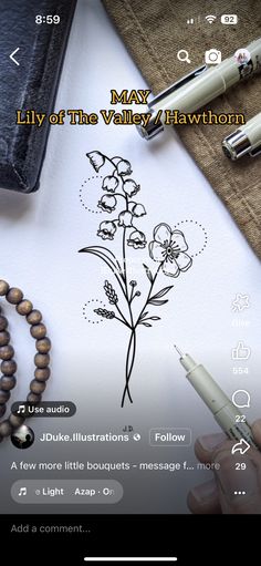 an image of a notepad with flowers on it and a pen next to it