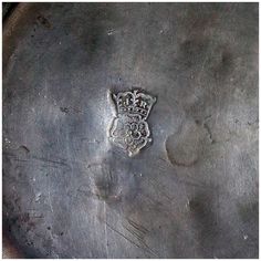 a silver plate with a crest on it