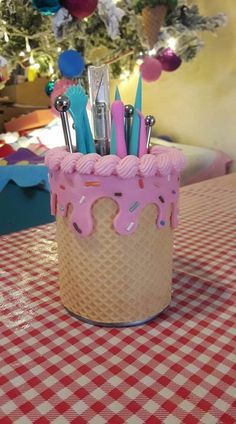 a pink frosted cake with sprinkles and forks in it on a table