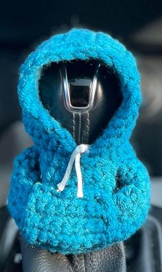 a cell phone in a blue knitted hoodie