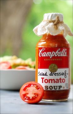 tomato sauce in a jar next to a bowl of tomatoes