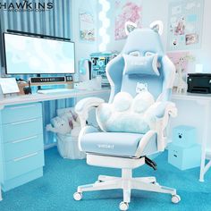 a blue and white office chair sitting in front of a computer monitor on top of a desk