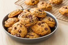 a bowl filled with chocolate chip cookies on top of a table