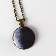 "Ever wonder what the moon looked like on your birthday? Or the birth dates of your children? The day you got married? Or the date of a person you love who passed on? This is a larger and more traditional version of our beloved birth moon necklace. Available in antique bronze or shiny silver tone, this 1 inch pendant hangs on an 18\" chain and makes a great gift. To order, please provide the following information in the \"message to seller\" at checkout: Date (in this format: MM/DD/YYYY), Time Z Moon Phase Necklace For Anniversary, Moon Phase Round Pendant Jewelry For Anniversary, Moon Phase Round Pendant Necklace For Anniversary, Anniversary Moon Phase Round Pendant Necklace, Sun And Moon Design Necklace For Anniversary, Anniversary Sun And Moon Design Necklace, Vintage Moon Phase Jewelry, Moon Print Moon-shaped Necklace Gift, Black Round Jewelry For Birthday Gift