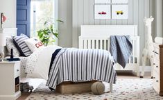 a child's bedroom decorated in white and blue