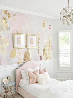 a bedroom with pink and gold decor on the walls