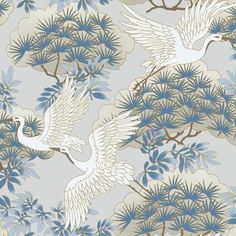 two white birds flying in the air over trees and flowers on a gray background with blue leaves