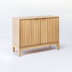 a wooden cabinet sitting on top of a white floor