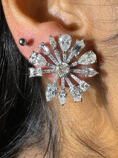 An exquisite pair of natural diamond flower clip-on earrings in 18k white gold, with a total diamond weight of 7.26 carats and a modern design. These earrings would likely feature a sophisticated floral motif with intricately set diamonds, perfect for adding a touch of elegance and brilliance to any look. The use of 18k white gold complements the diamonds by enhancing their sparkle, while the clip-on style adds comfort and versatility! Diamond Flower, Flower Clip, Flower Earrings, Floral Motif, Jewelry Earrings Studs, Clip On Earrings, Natural Diamonds, Modern Design, Sparkle