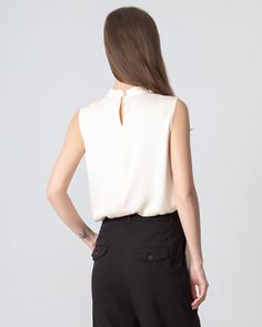 Type: Women's Tie Neck Blouse. Material: 19 Momme Luxury Mulberry Silk. Features: Satin, wear-resistant and stylish. Details: Classic Solid Color, Designed Sleeveless&Tie Neck, Regular Fit. Introducing our sleeveless silk blouse for women—a versatile essential that effortlessly transitions from formal to casual. Crafted from luxurious silk fabric, the top features a v neckline and a front tie for customizable styling. Whether you prefer a classic knot or a playful bow, this v-neck silk top is pe Fitted Sleeveless Solid Color Blouse, Chic Stretch Cami Blouse, Chic Stretch Tank Blouse, V-neck Tank Top For Office In Summer, Chic Stretch Vest Blouse, Sleeveless Blouse For Business Casual, Solid Color Sleeveless Blouse For Work, Elegant Stretch Tank Blouse, Sleeveless Business Casual Blouse