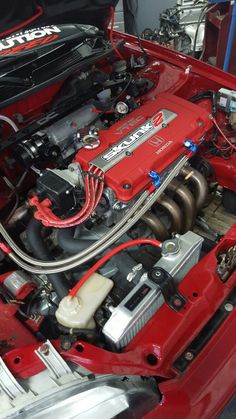 the engine compartment of a red sports car