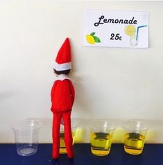 an elf is standing in front of lemonade cups