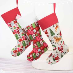 two christmas stockings sitting on top of a table