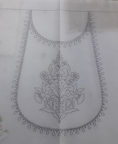 a drawing of a dress with flowers and beads on the neckline is shown in black ink