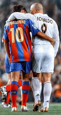 two soccer players embracing each other on the field