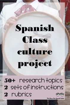 a man holding a large white object with spanish class culture project written on it