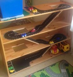 a wooden shelf with toy cars and trucks on it in a child's room