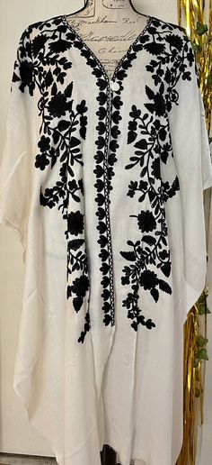 It is a beautiful long cape shawl style poncho for women. Beautiful Kashmiri Ari embroidery on it. It is open from front and a button on front. Sides are also open. It is a long length poncho . Fabric pashmina. Color white . Black Thread embroidery on it. Back side also embroided. Front and back length are same almost 43 to 44 inches. No return or exchange please. Traditional Shawl Kimono For Spring, Traditional Spring Kimono Shawl, Long Poncho For Festivals, Traditional One Size Shawl Kimono, Traditional One-size Shawl Kimono, Traditional One Size Kaftan, Traditional Long Sleeve Embroidered Poncho, Bohemian Dupatta With Embroidered Border For Spring, Traditional One-size Long Sleeve Cape