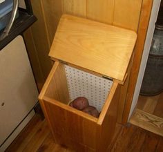 a wooden box with some potatoes in it