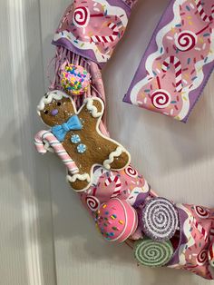 a door hanger decorated with candy and a gingerbread