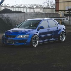 a blue car parked in front of a building