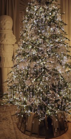 a white christmas tree with lights in a room