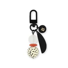 a black and white keychain with an object hanging from it's side