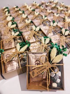 several boxes filled with cookies and candy on top of a white table covered in twine