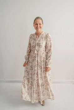 The Adriana Floral Maxi Dress in Hazelnut is such a feminine and charming dress! With delicate covered-button front closure, a ruffled neckline and drawstrings, this dress is both pretty and practical for all women, but especially nursing mamas! The tiered layers add a touch of elegance, making it perfect for any occasion and a treasure you'll enjoy for many years. Style: functioning buttons, tiered skirt, long sleeves, fully lined Fit: true to size, although if you're between sizes, you would b