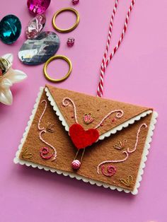 an ornament with a heart on it next to some scissors and other decorations