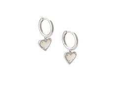 Kendra Scott Ari Heart Huggie Earrings - Earring : Rhodium Ivory Mother-of-Pearl : The Kendra Scott Ari Heart Huggie Earrings are a beautiful hoop with prong-set stone heart pendants. Please refer to color selection for stone detail. 14K gold, 14K rose gold, or rhodium - all plated over brass. Lever back closure. Imported. Measurements: Width: 4 7 in Height: 11 13 in Drop: 2 5 in Weight: 0.1 oz White Gold Huggie Jewelry For Valentine's Day, Elegant Huggie Earrings With Heart Charm, Valentine's Day White Gold Huggie Jewelry, Sterling Silver Dangle Heart Earrings, Tarnish Resistant, Silver Sterling Heart Charm Huggie Earrings, Silver Sterling Huggie Earrings With Heart Charm, Elegant Dangle Huggie Earrings With Heart Charm, Silver Heart Charm Huggie Earrings, Tarnish Resistant Sterling Silver Dangle Heart Earrings