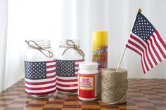 the american flag is next to two jars with twine and glue on them, along with other craft supplies