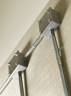 two metal poles are attached to the wall