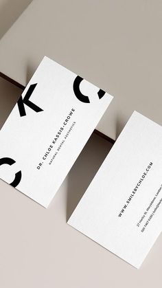 two business cards sitting on top of each other with the letters k and c printed on them