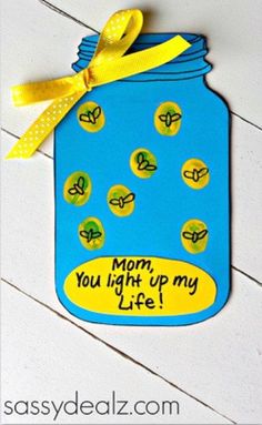 a blue mason jar with yellow ribbon and words that say mom you light up my life