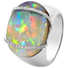 "La Gioconda" opal ring showcases an eye-catching opal (14.52ct) from our own mines in Jundah-Opalville. Inspired by the Mona Lisa’s enigmatic smile, this piece features two intricate lines of brilliant-cut diamonds embracing a light boulder opal. Set in 18K white gold, this ring is a discreet yet powerful fashion statement. Designed by Renata Bernard. The gemstone at the centre of this opal ring is an Australian boulder opal from Opal Minded's own opal mines in Jundah-Opalville in Queensland. Precious opal's distinctive quality is its "play of colour," a phenomenon which manifests in opal's colours shifting and changing as the gem moves. Australian opals, in general, are the quality benchmark for the world family of opals owing to their durability and beauty. Particulars: Size & Stone Mea Powerful Fashion, Vintage Opal Engagement Ring, The Mona Lisa, Ammolite Jewelry, Peruvian Blue Opal, Precious Opal, Diamond Cocktail Ring, Gold For Sale, Australian Boulder Opal