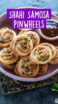 a plate filled with rolls and dipping sauces