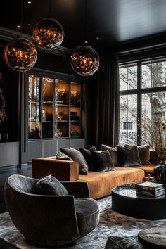 a living room filled with lots of furniture and large glass balls hanging from the ceiling