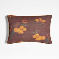 a brown and yellow pillow with flowers on it