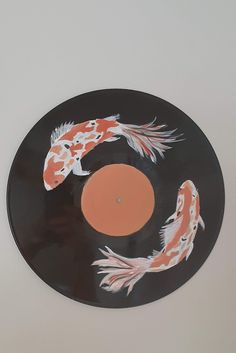 a record with two koi fish painted on it