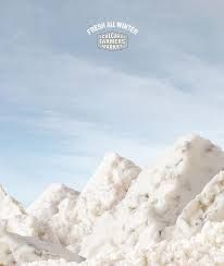 a man riding skis on top of snow covered ground