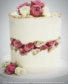 a white cake with pink and white flowers on top