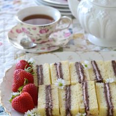 a plate that has some cake and strawberries on it