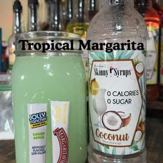 a bottle of coconut water next to a jar of coconut juice