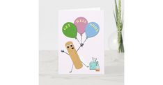 a greeting card with a cartoon character holding balloons in the shape of a long bone