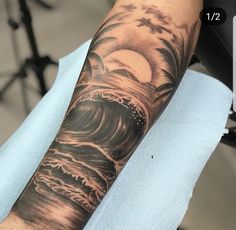 a man's arm with a wave tattoo on it