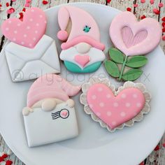 decorated cookies on a plate with hearts and envelopes