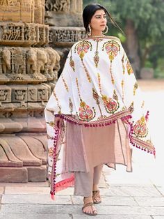 This Off-White shawl/dupatta is crafted in organic khadi cotton fabric. It is Heavily aari Embroidered with different kalash motif. It is fenced with wine dyed cotton tassel lace and fringe lace on both the ends. For winters it is perfect as a fancy shawl and for festive it is perfect to carry on your fancy outifit. Color: Off-white Fabric: 100% cotton base khadi Fabric Work Details: Embroidered, embellished with fancy laces and fringes Meausrements: Length - 200 CM Width - 75 CM Note: The produ Shawl Dupatta, Khadi Fabric, Fancy Shawl, Designer Shawl, Tassel Lace, Red Shawl, White Shawl, Winter Shawl, Aari Embroidery