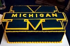 a cake that is decorated with the michigan football team's name and number on it