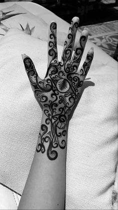 a person's hand with an intricate design on it